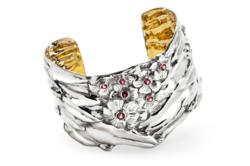 The silver cuff in Cherry Blossom motif from American Estate Jewelry.